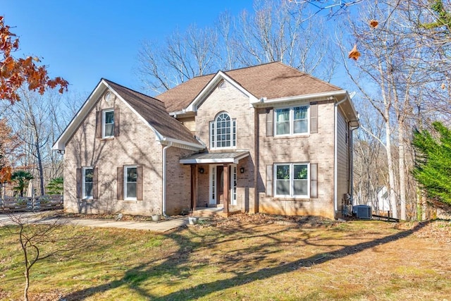 view of front of home featuring central AC and a front lawn