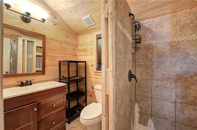 1195 Grady Rd, Rockmart, GA 30153 - bathroom with lofted ceiling, tiled shower, vanity, toilet, and wood walls