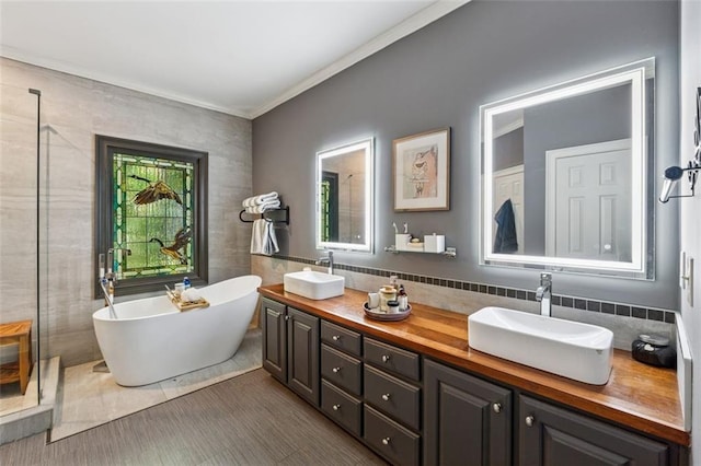 1042 Bailey Rd, Woodstock, GA 30188 - bathroom featuring tile walls, a freestanding tub, double vanity, ornamental molding, and tile patterned flooring