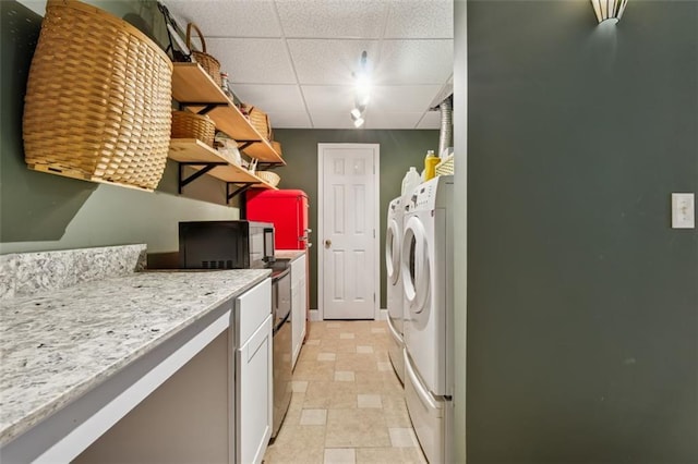 1042 Bailey Rd, Woodstock, GA 30188 - laundry room featuring washing machine and dryer and cabinet space