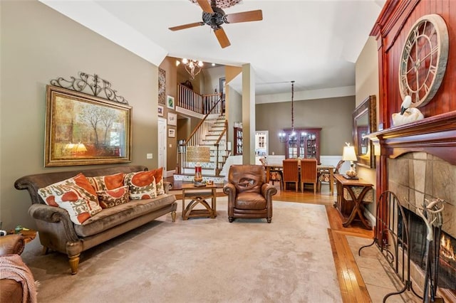1042 Bailey Rd, Woodstock, GA 30188 - living room with a chandelier, a tiled fireplace, stairway, light wood finished floors, and a high ceiling