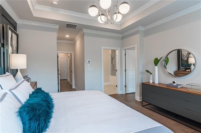 bedroom featuring ornamental molding, dark wood-type flooring, a tray ceiling, and a notable chandelier