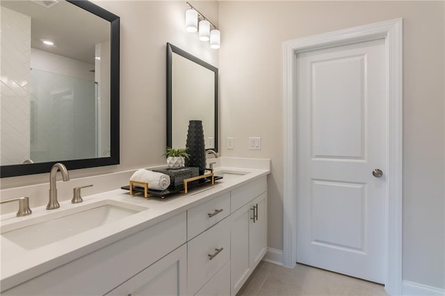 bathroom featuring a shower with shower door, tile patterned flooring, and vanity