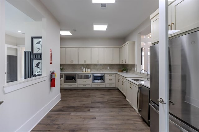 kitchen featuring dark hardwood / wood-style flooring, sink, stainless steel appliances, and white cabinets