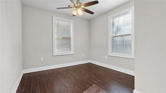 spare room featuring dark wood-type flooring and ceiling fan