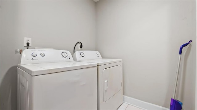 laundry area featuring light tile patterned floors and washer and dryer