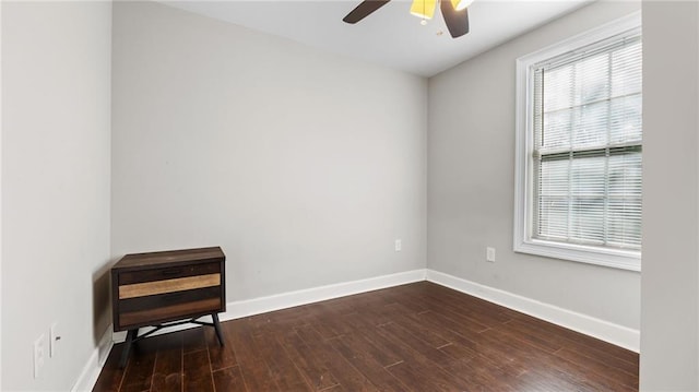 empty room with dark wood-type flooring and ceiling fan