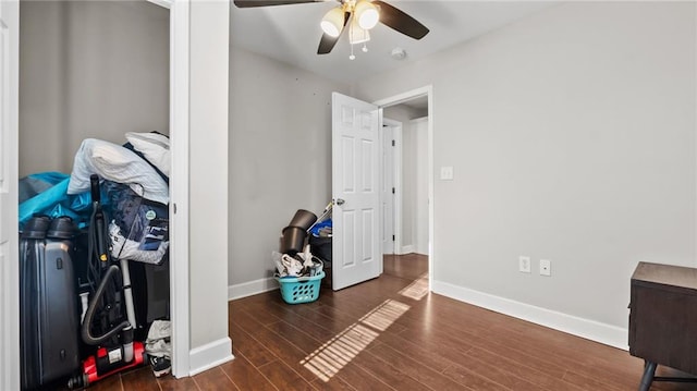 interior space featuring dark wood-type flooring and ceiling fan