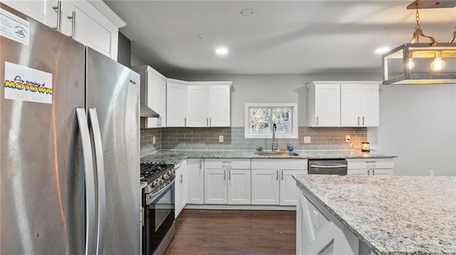 kitchen featuring sink, dark wood-type flooring, appliances with stainless steel finishes, light stone counters, and white cabinets