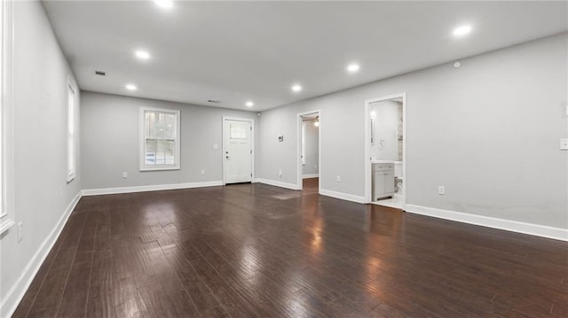 unfurnished living room featuring dark hardwood / wood-style flooring