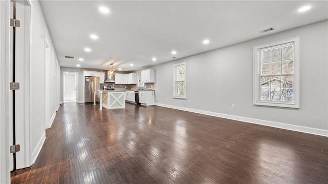 unfurnished living room featuring dark wood-type flooring