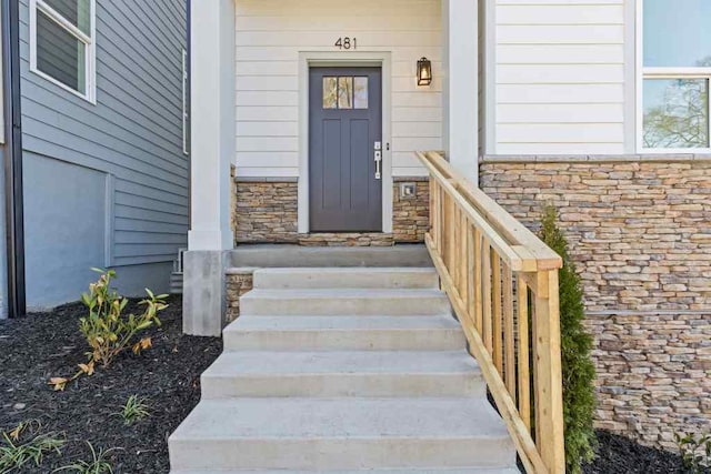 entrance to property with stone siding
