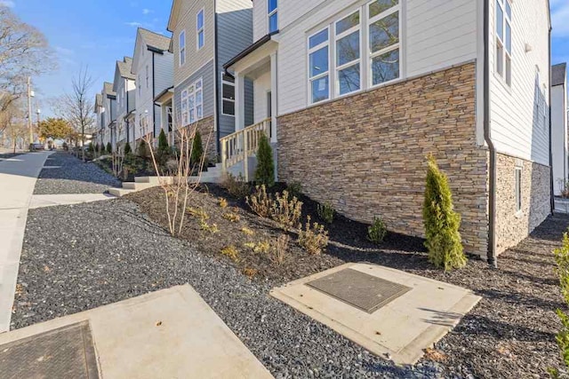 view of home's exterior featuring stone siding and a residential view