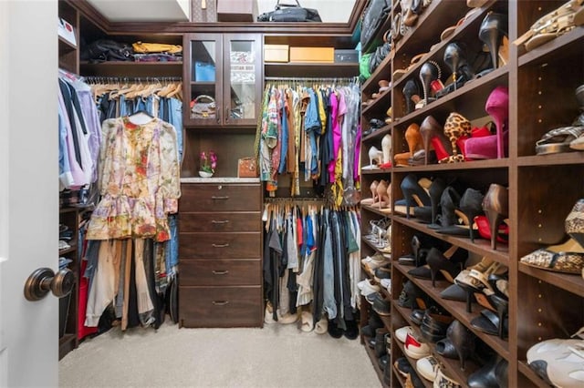 walk in closet with carpet floors
