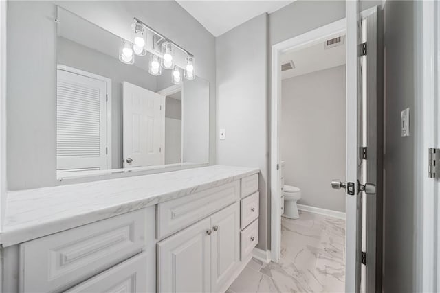 23307 Plantation Dr NE, Atlanta, GA 30324 - bathroom with marble look tile flooring, vanity, and toilet