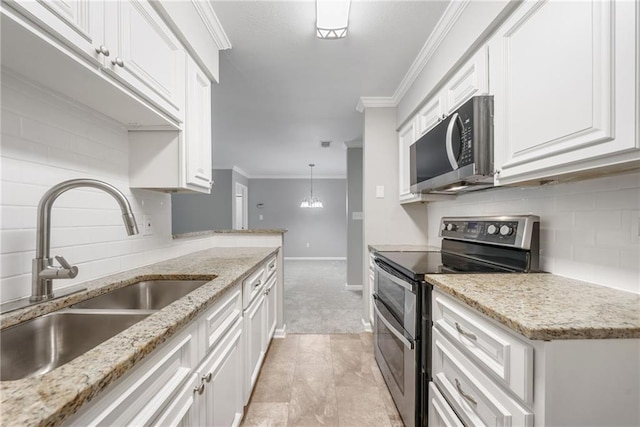 23307 Plantation Dr NE, Atlanta, GA 30324 - kitchen featuring stainless steel appliances, a sink, tasteful backsplash, white cabinetry, and crown molding