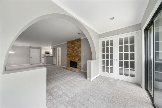23307 Plantation Dr NE, Atlanta, GA 30324 - unfurnished living room with crown molding, carpet, french doors, a fireplace, and baseboards