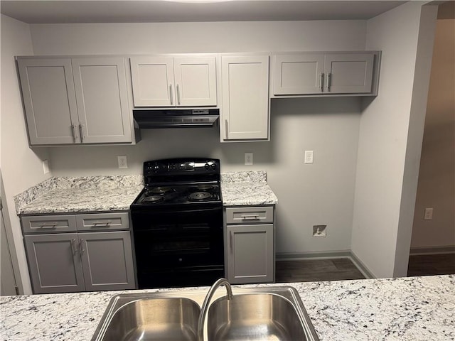 kitchen featuring electric range, ventilation hood, and gray cabinetry