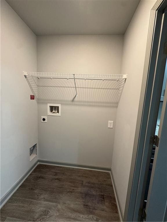 laundry area with laundry area, baseboards, dark wood-type flooring, hookup for a washing machine, and hookup for an electric dryer