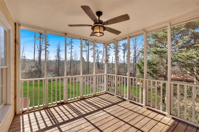 unfurnished sunroom with a healthy amount of sunlight and a ceiling fan