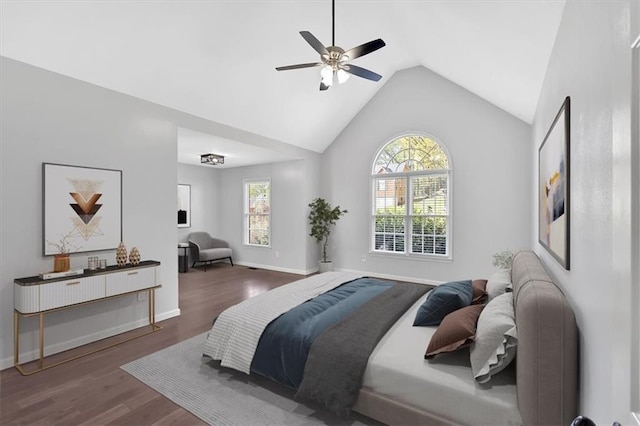 bedroom with wood finished floors, baseboards, a ceiling fan, and vaulted ceiling