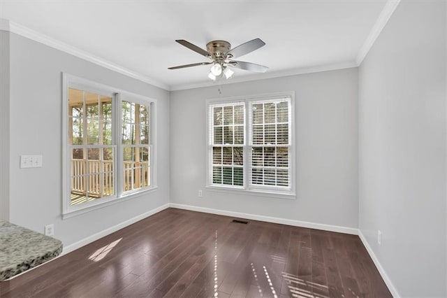 empty room featuring baseboards, ceiling fan, and wood finished floors