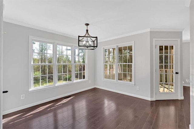 unfurnished dining area with a chandelier, crown molding, baseboards, and dark wood-style floors