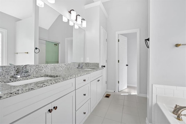 bathroom featuring a shower stall, tile patterned floors, a garden tub, and a sink