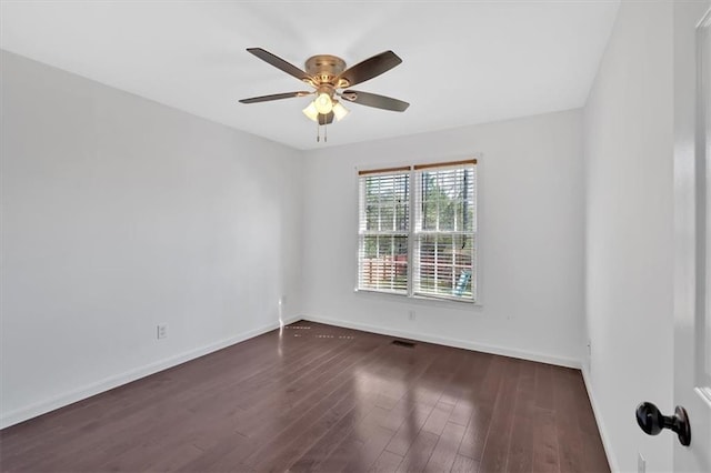 unfurnished room with visible vents, baseboards, a ceiling fan, and dark wood finished floors