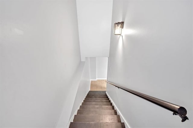 stairway featuring wood finished floors