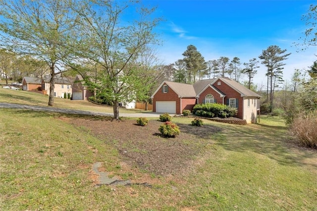 view of front of home with a front yard, an attached garage, brick siding, and driveway