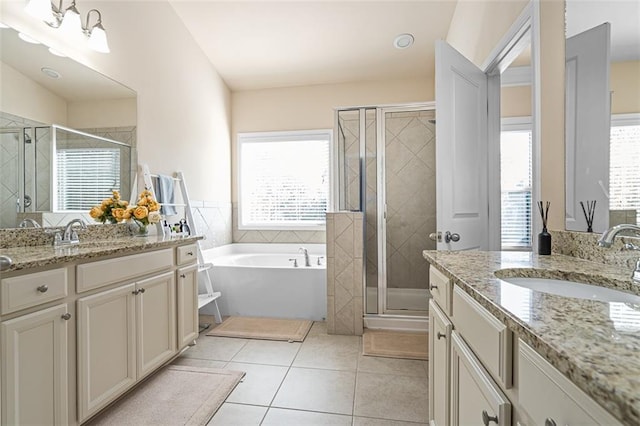 bathroom with a sink, a shower stall, and tile patterned floors