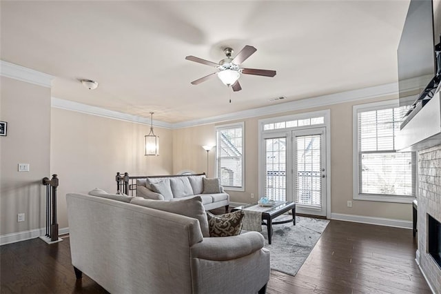 living area with dark wood-style floors, a fireplace, visible vents, ornamental molding, and baseboards