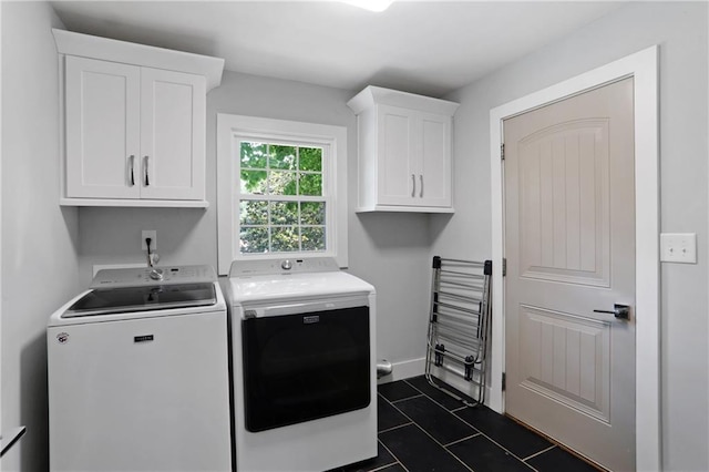 2445 Kings Point Dr, Dunwoody, GA 30338 - washroom with cabinet space, washing machine and clothes dryer, dark tile patterned flooring, and baseboards