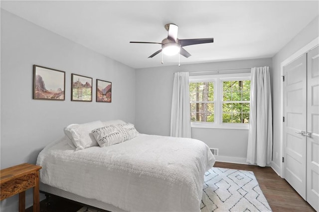 2445 Kings Point Dr, Dunwoody, GA 30338 - bedroom featuring dark wood-style flooring, a ceiling fan, and baseboards