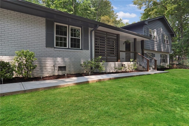 2445 Kings Point Dr, Dunwoody, GA 30338 - view of front facade with brick siding, a front yard, a porch, and crawl space