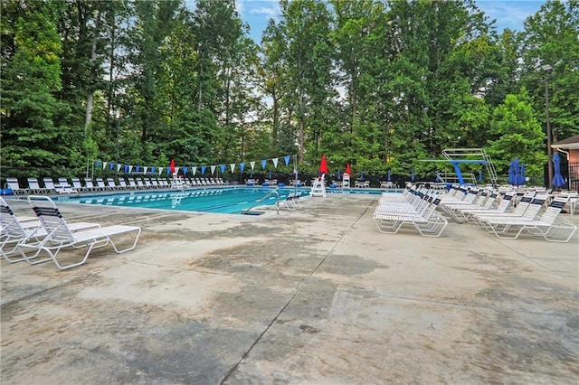 2445 Kings Point Dr, Dunwoody, GA 30338 - community pool with a patio area and view of wooded area