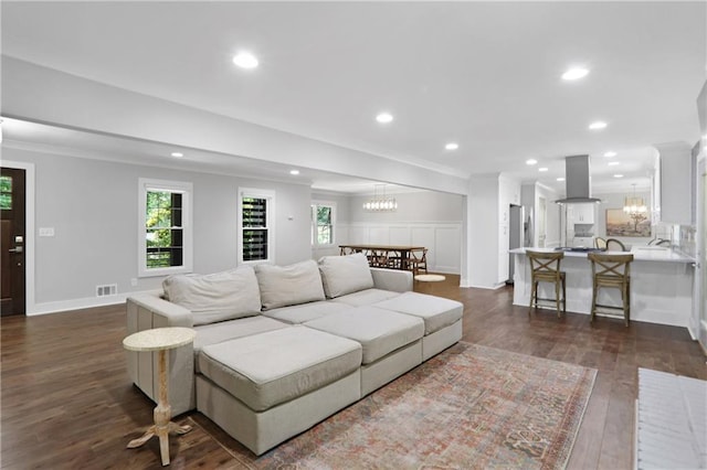 2445 Kings Point Dr, Dunwoody, GA 30338 - living room featuring a chandelier, dark wood finished floors, ornamental molding, recessed lighting, and baseboards