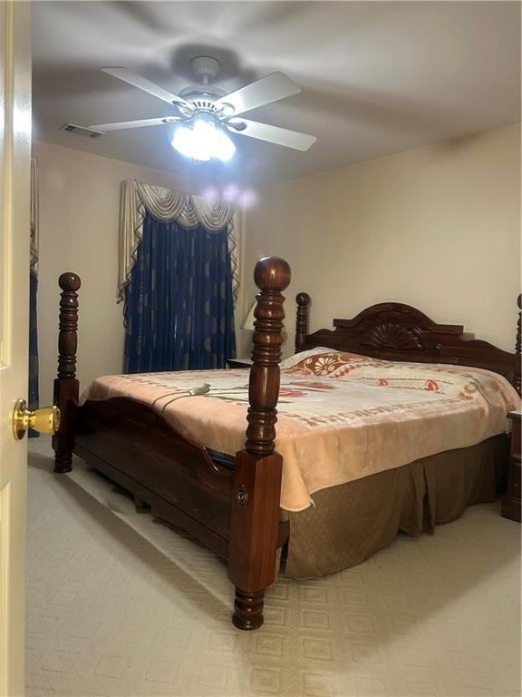 bedroom with light colored carpet and ceiling fan