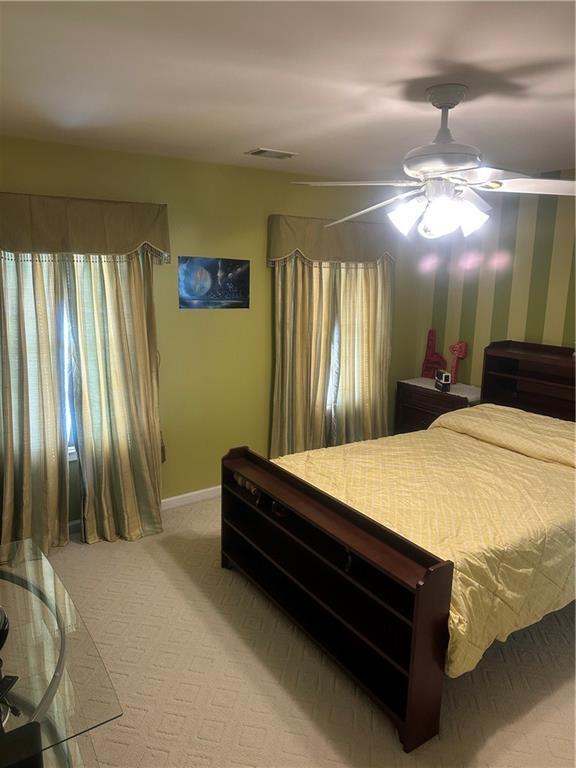 bedroom featuring carpet and ceiling fan