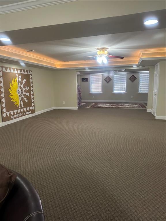 unfurnished living room featuring dark hardwood / wood-style floors, a towering ceiling, a fireplace, and ornamental molding