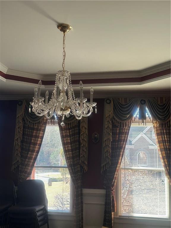 interior details featuring ornamental molding and a notable chandelier