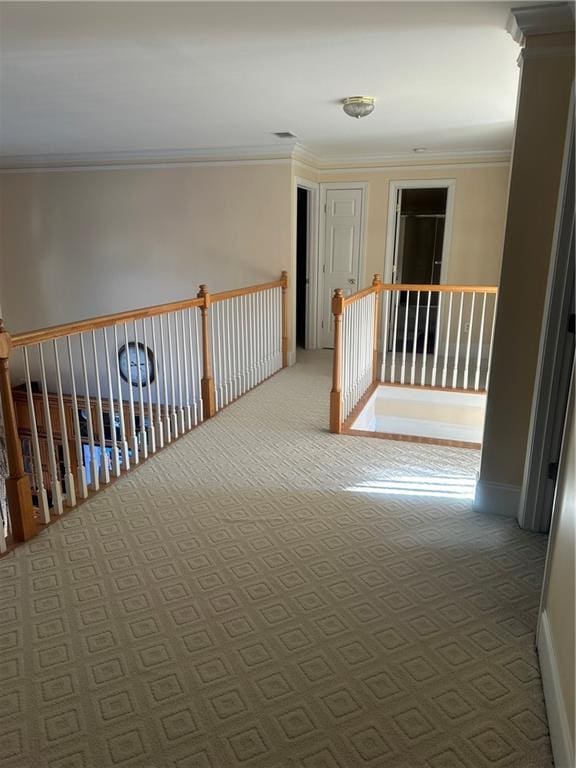 corridor with carpet and crown molding