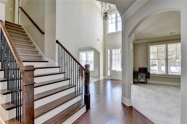 3191 Lake Mcginnis Dr, Suwanee, GA 30024 - entrance foyer with arched walkways, crown molding, plenty of natural light, and stairs