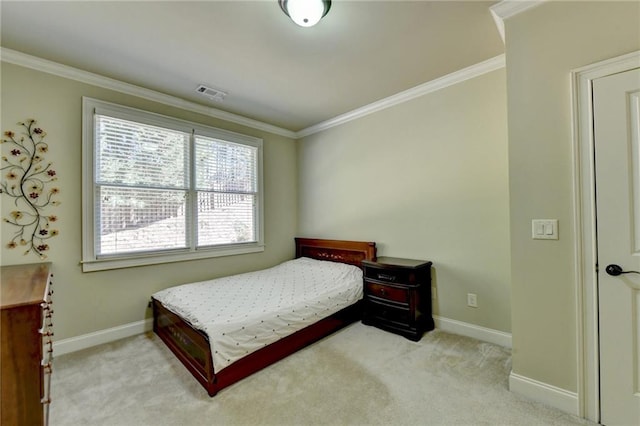 bedroom with ornamental molding and light colored carpet