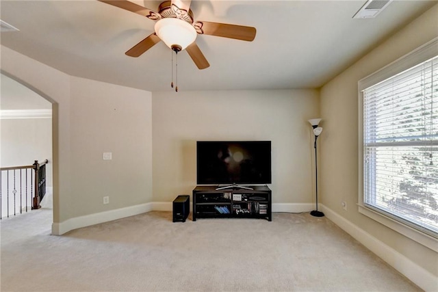 3191 Lake Mcginnis Dr, Suwanee, GA 30024 - living room featuring light colored carpet, arched walkways, a ceiling fan, and baseboards