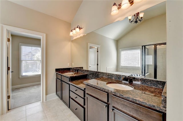 bathroom featuring a chandelier, vaulted ceiling, vanity, plus walk in shower, and tile patterned flooring