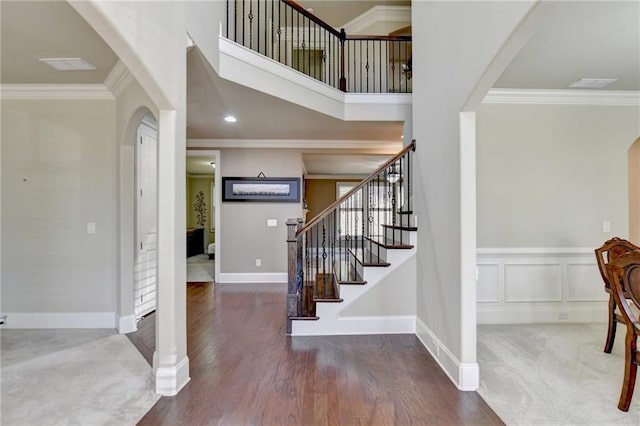 3191 Lake Mcginnis Dr, Suwanee, GA 30024 - entryway with arched walkways, stairs, crown molding, baseboards, and a high ceiling
