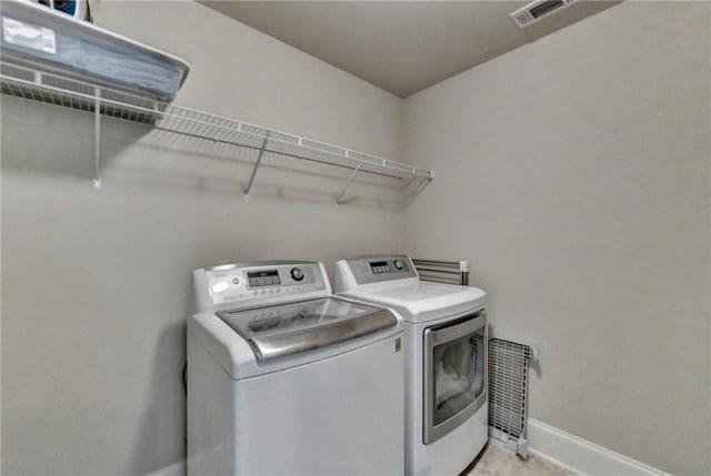 clothes washing area with washer and clothes dryer