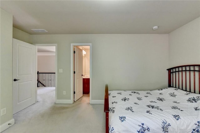 carpeted bedroom featuring ensuite bath